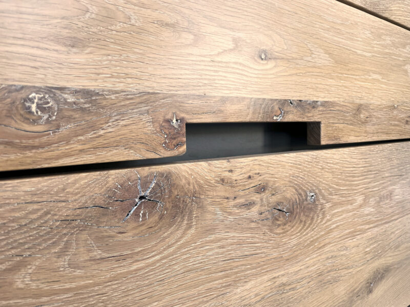 Light oak island with pale grey worktop and cream cabinetry on parquet flooring